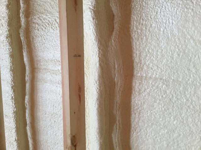 The home's exterior walls consist of two 2-by-4 walls. The interior face of the exterior wall is completely covered with 2 inches of closed-cell spray foam, then the double wall cavity is filled with dense-packed cellulose for a continuous R-49 blanket of wall insulation.