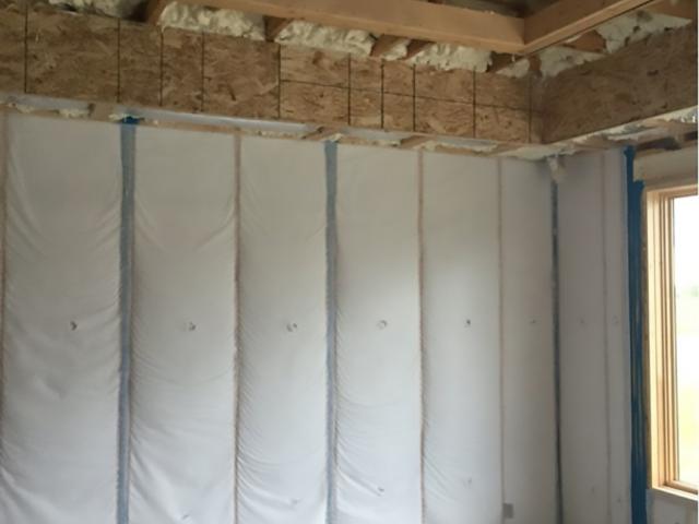 The rim joists and top plates are air-sealed and insulated with open-cell spray foam while closed-cell spray foam air seals and insulates behind tubs, showers, and fireplaces.