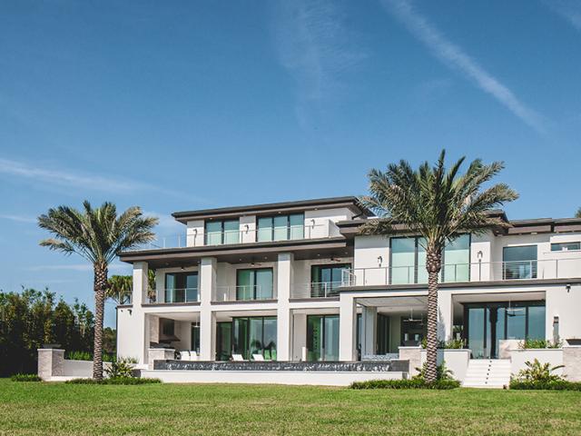 Deep overhangs, light-colored walls and roofing, and advanced-technology low-e3 windows minimize heat gain.