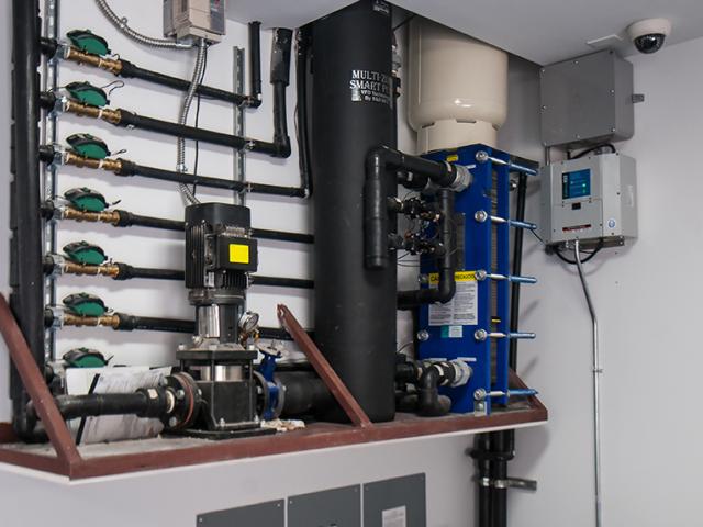 A ground-source heat pump provides very efficient heating and cooling (17.73 EER or 22-28 SEER) as well as potable hot water.