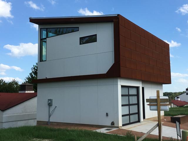 Fiber-cement siding protects the sides of the compact structure.