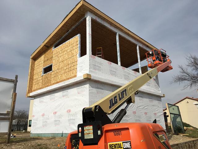 House wrap provides an air and water barrier around the home.