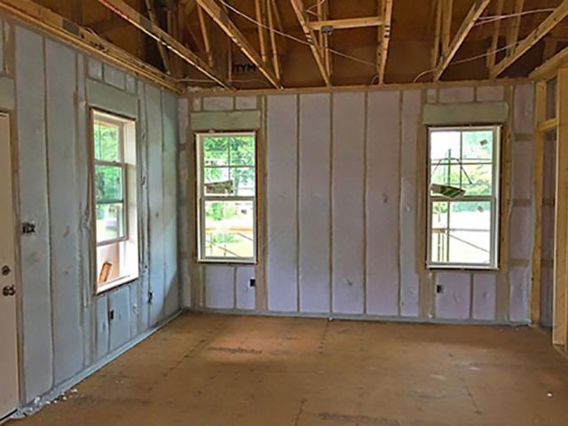 The 2-by-4, 16-inch on-center walls are constructed with advanced framing techniques like open headers over windows and ladder blocking at intersecting walls, which provides more space for the R-15 blown fiberglass insulation.