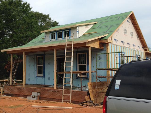 The roof decking consists of a coated OSB that is taped at the seams to provide a water-resistant covering under the 30-year asphalt shingles.