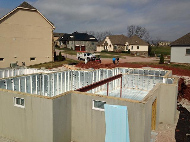 The basement is constructed with pre-cast concrete walls lined with R-21.3 foil-faced rigid foam while an R-10 layer of XPS rigid foam covers the ground under the slab.