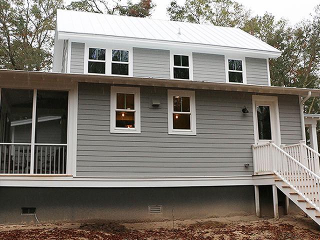 The white metal roof, deep overhangs, and porches help to minimize solar heat gain inside the home.