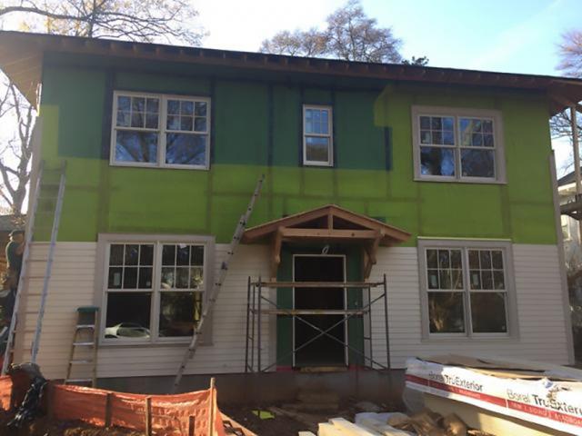 A mesh plastic rainscreen product separates the coated OSB from the siding, providing a drainage and ventilation gap.