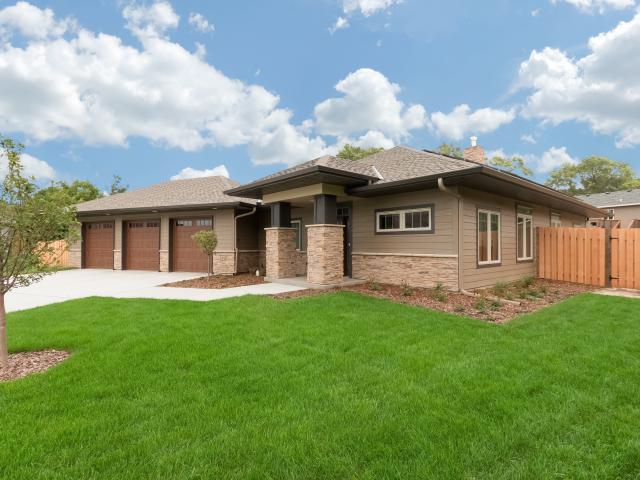 Deep overhangs and a covered front porch provide solar window shading from high summer sun and help keep the entryway snow-free in winter. Severe storm damage is minimized with dry-by-design roof construction including ice and water barrier underlayment, metal flashing, and a hip roof design.