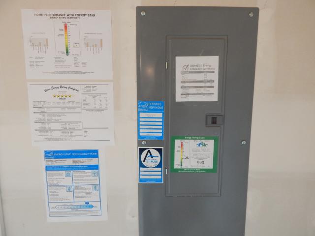 The electric panel has home performance program labels, including the Home Energy Rating System (HERS) score, ENERGY STAR Certified Home, and EPA Indoor airPLUS.