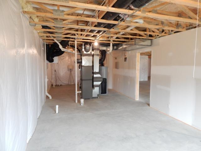 The high-efficiency gas furnace and air conditioner are housed in the unfinished, insulated basement.