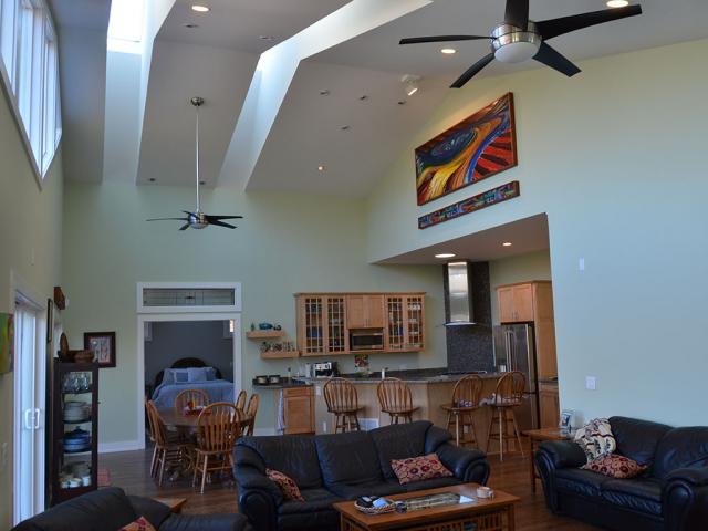 Tall ceilings and high-performance windows and skylights in the great room help flood the home’s interior with natural daylight; the remote-controlled skylights and energy-saving ceiling fans provide ventilation and cooling when outdoor humidity is low.