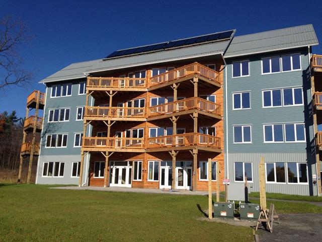 AquaZephyr, LLC, built this 22,600-square-foot, 15-unit multifamily building in Ithaca, New York, to the performance criteria of the U.S. Department of Energy Zero Energy Ready Home (ZERH) program. The angular decks and entry area were designed to increase the amount of southern exposure for passive solar gain.