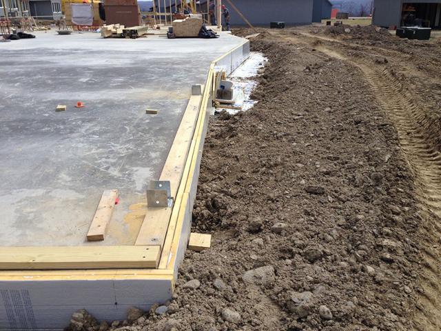 Two layers of rigid foam insulation wrap the foundation slab, helping to keep floors warm in the winter.