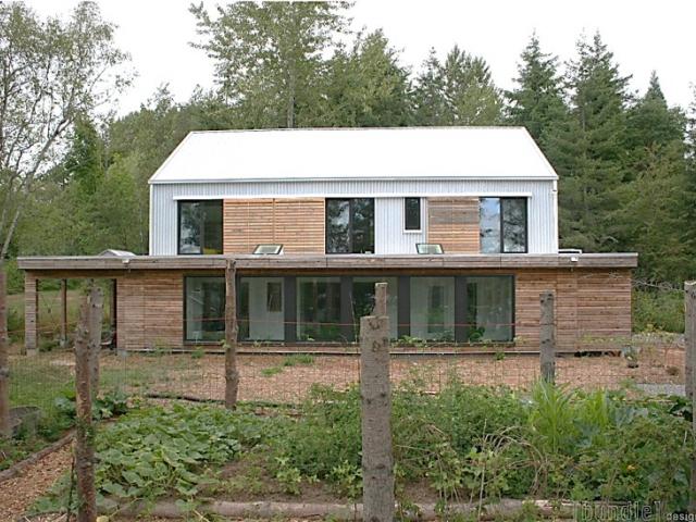 The harvested rainwater irrigation system provides water to the large vegetable garden.