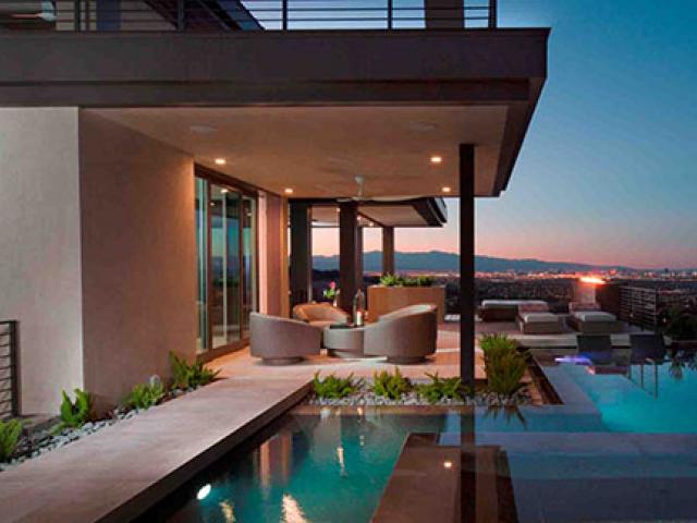 Deep overhangs provide numerous areas for shaded outdoor seating in this hot-dry climate home.