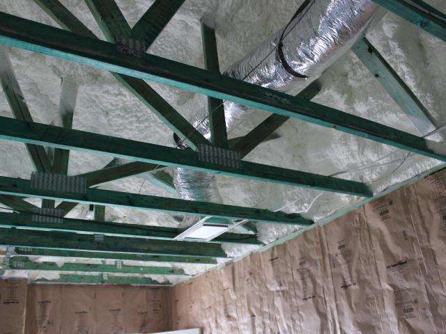 This sealed attic has 5.5 inches (R-20) of spray foam insulation along the underside of the roof deck providing a conditioned attic space for the heating and cooling ducts.