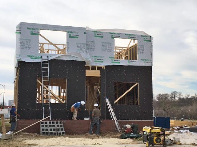 The builder installed an exterior wall water barrier including house wrap and graphite-enhanced rigid R-5 foam insulation instead of OSB sheathing to help keep water out of the walls.