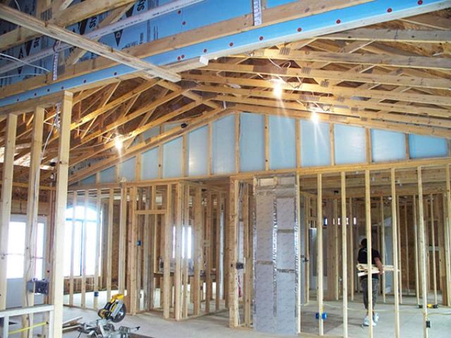 Attic knee walls are insulated with rigid foam and sealed with spray foam to help form a continuous draft barrier around attic rooms.