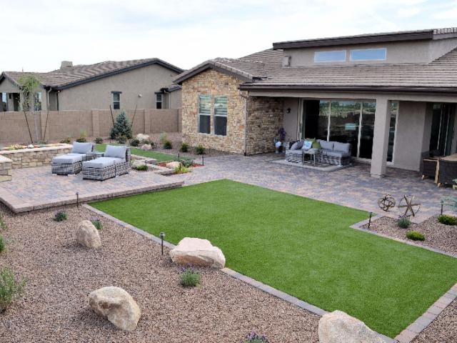 The draught-tolerant landscape includes native plants with drip irrigation controlled by a smart timer that adjusts watering based on local weather conditions. Note that the roof line is continuous. There are no breaks for vents or pipes, so the insulation can be continuous and there are less chances of roof leaks.