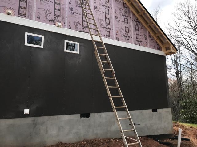 The exterior walls were covered with a 1-inch-thick sheet of extruded polystyrene rigid foam that provides R-5 of continuous insulation. With the seams taped, it also provides a continuous air and weather-resistant barrier so no house wrap is needed.