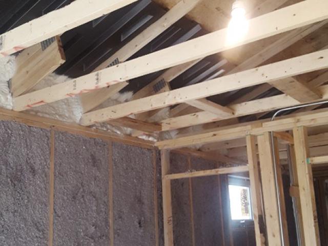 The walls are filled with R-26 of blown cellulose. The raised heel energy trusses are spray foamed to seal the baffles, which will provide a ventilation path to the soffit vents. Interior top plates will also be spray foamed before 16 inches (R-60) of cellulose is blown over the attic floor.