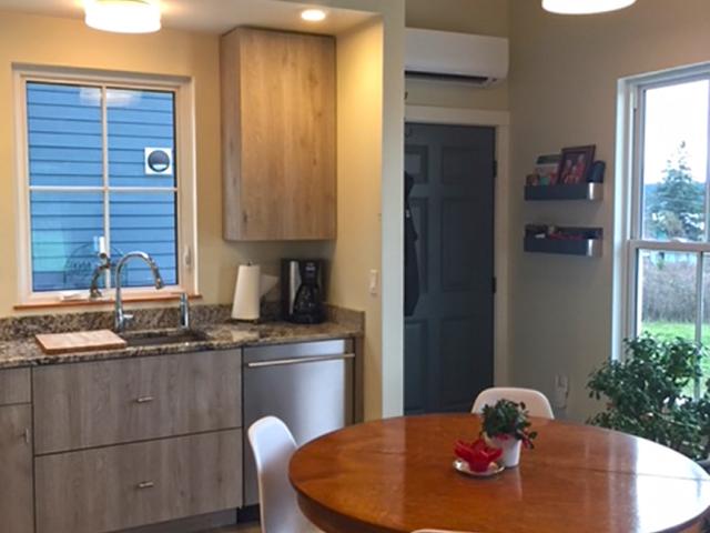 A single-head ductless mini-split heats the entire home. Mounted above the main entry door, it directs heat throughout the main living area, some of which is absorbed and then redistributed by the insulated concrete floors.