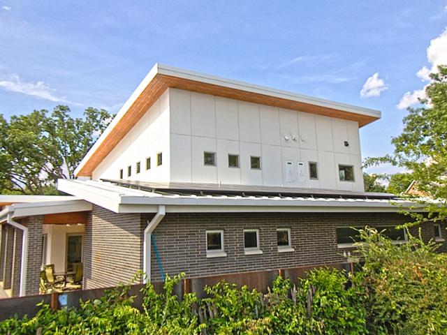 Fiber cement covers the 2-by-6 advanced framed walls, which are sheathed with coated OSB and 1/2-inch rigid foam. Metal roofing and TPO tops the roof. Rigid foam was installed above the OSB roof decking then covered with a moisture and air barrier of ice-and-water-resistant membrane.