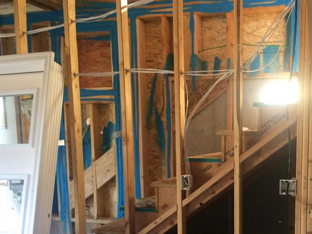 A sprayer-applied air sealant is used to seal seams in framing, where top plates meet the ceiling drywall and where bottom plates meet the subfloor.