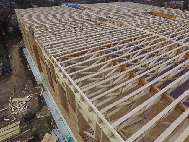 The open-web roof joists will be filled with open-cell spray foam to provide R-57 of continuous insulation above the vaulted ceilings. The open-web roof and floor joists and other engineered structural products, such as laminated veneer lumber and I-beams, combine efficient raw material use with adhesives to provide more load-bearing capacity than traditional lumber, while resisting shrinking, twisting, splitting, and warping.