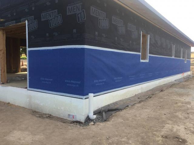 The home is wrapped with a smart vapor-open house membrane that is taped with a sturdy air-sealing tape. The membrane stops drafts and liquid water but allows vapor through.