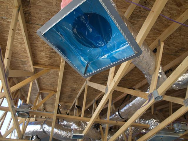 The HVAC ducts are covered during construction to keep debris out of the air distribution system. The attic will be spray foamed with 5.5 to 7.5 inches of open-cell spray foam providing a protected environment for the ducts and a temperate area for attic storage.