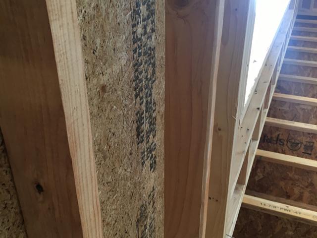 The walls were constructed of 2-by-4 studs staggered on 2-by-6 plates, providing space to weave insulation in between the studs and forming a continuous thermal break through the wall. The blown fiberglass provided R-23 of insulation.