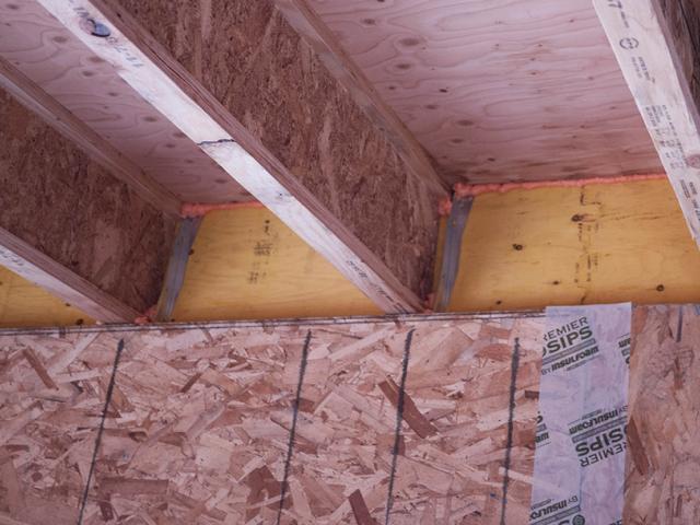 Air sealing measures include caulking at rim joists and taping of SIP panel seams.