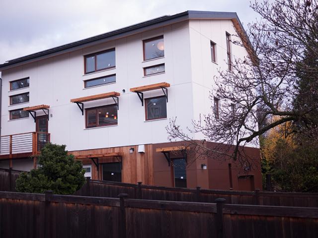 Durable metal roofing, fiber cement siding, and redwood detailing provides a long-lasting exterior for the Pacific Northwest winters.