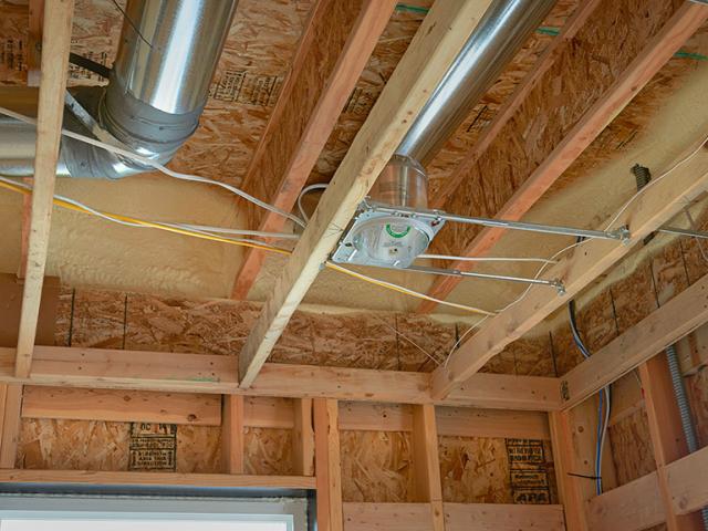 The HVAC ducts are located between floors in conditioned space, protecting them from cold attic conditions.