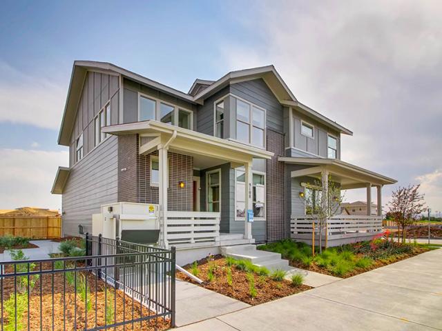 Deep overhangs and porches protect windows and walls from summer sun and winter snows in this Denver area home.