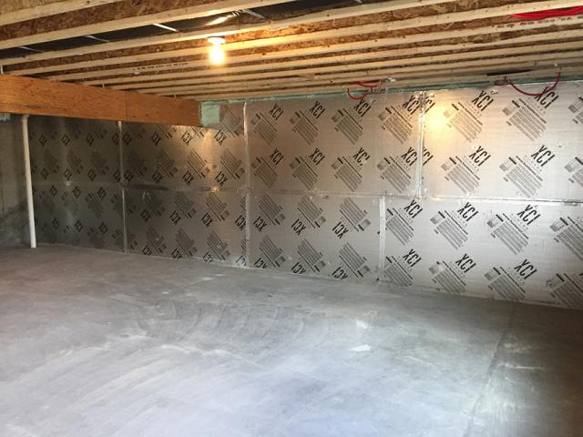 The conditioned basement is insulated on the exterior with 1 inch of XPS R-5 rigid insulation and on the interior with 1 inch of polyiso R-6.3 rigid insulation.