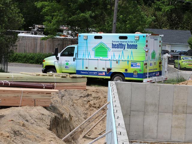 The basement wall is insulated on the exterior with 2 inches of rigid foam; an additional 2 inches was installed under the slab to wrap the foundation in a continuous thermal layer.