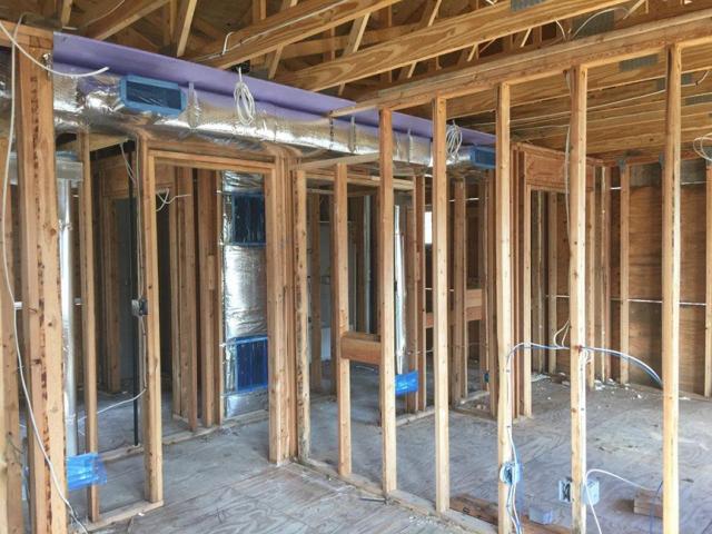 Drywall was installed before installing the duct chase to ensure the ducts will be separated from the attic.