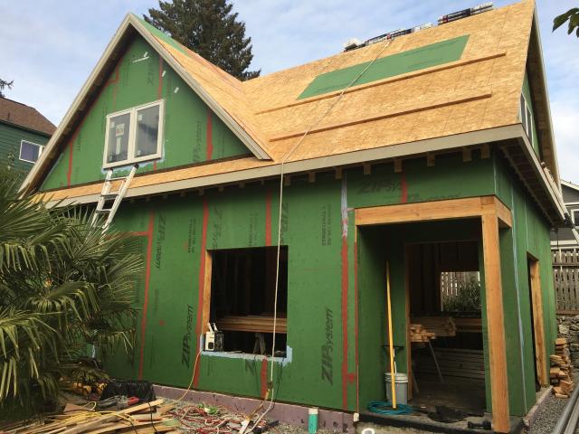 The coated OSB sheathing is sealed at the seams with a paint-on flashing to provide a seamless weather-resistant barrier over the walls. A paint-on flashing seals and protects the window sills.