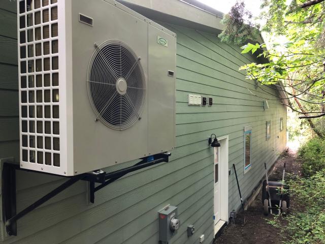 The air-to-water heat pump provides all the heat and hot water this home needs with a COP of 3.92, outperforming a ground source heat pump in this marine climate on a year-round basis.