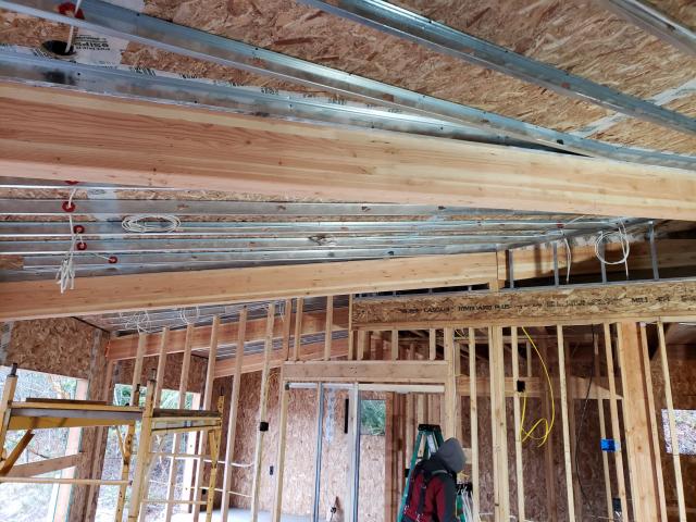 Metal framing was installed below the SIP roof panels to provide a service cavity for fire-suppression sprinklers and light fixture wiring.