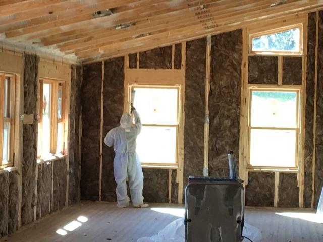 Low-expanding foam around all window and door openings is one of many air-sealing details in the house. Also, thorough caulking of all top plates, bottom plates, wall panel joints, wall panel centers, and all electrical, plumbing, and HVAC penetrations; spray foam attic insulation; sill-seal gaskets under the sill plates; and gaskets between the plywood sheathing and the framing of each wall panel. These details helped the house achieve an airtightness of 1.44 air changes per hour at 50 Pascals.