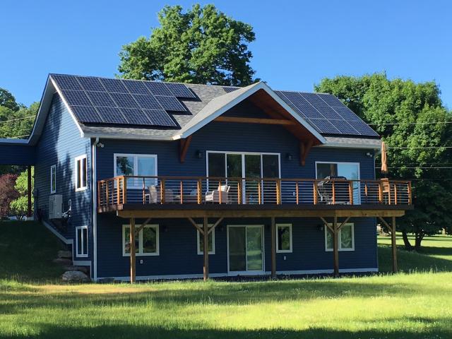 A 10.21-kW array of PV panels sits atop the south-facing roof of the home. These panels reduce the home's annual electric bill from a projected $3,930 to about $90 per year, or less than $8/month.