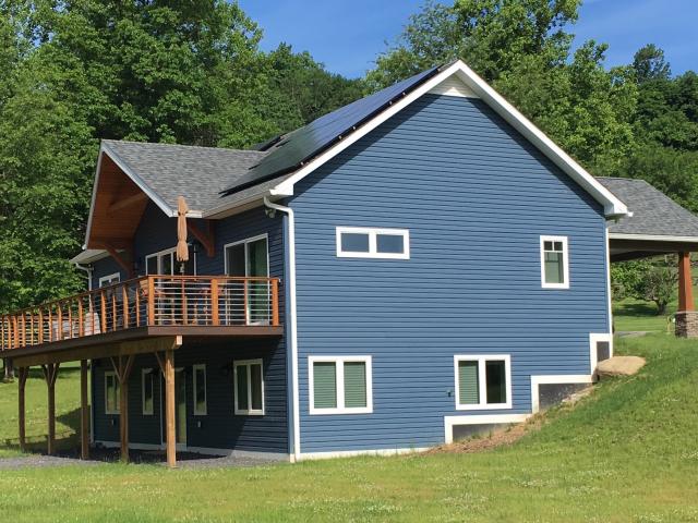 The simple rectangular shape of the two-story plus basement home contributes to its energy efficiency and fits in with the region's Dutch colonial architectural style.