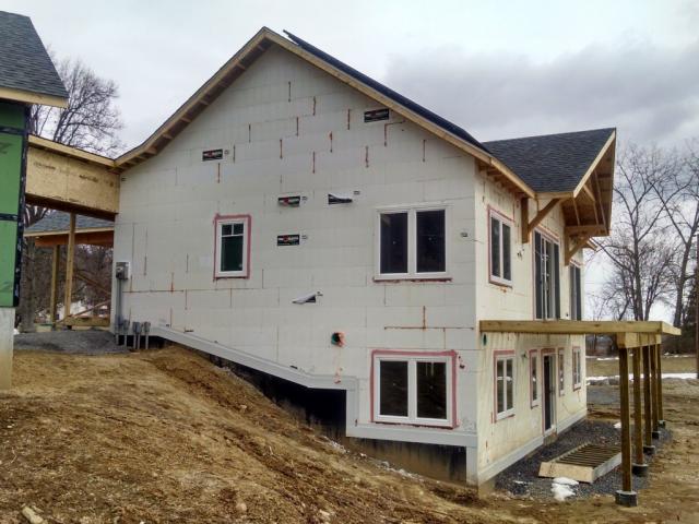 The ICF blocks are stacked to form 11-inch-thick walls with reinforced concrete cores and layers of continuous rigid foam.