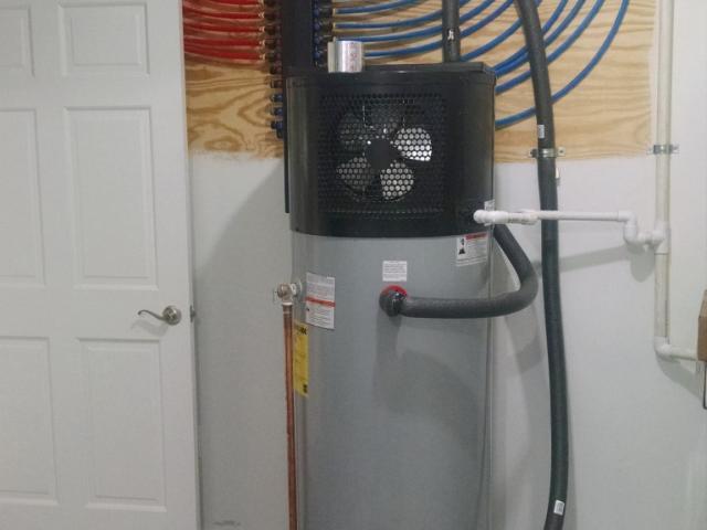 A heat pump water heater with a 50-gallon tank and an efficiency of 3.53 EF is located in the mechanical room, which is within the conditioned area of the home. A central manifold distribution system speeds the hot water to faucets.