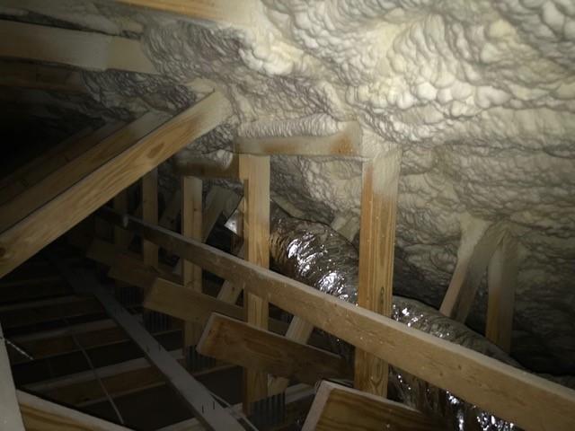 The attic is insulated on the underside of the OSB roof decking with 3 inches (R-19.5) of closed-cell spray foam plus 7 inches (R-25.2) of open-cell spray foam for a total insulation value of R-44.7, providing a climate-controlled location for the top-floor HVAC ducts. The roof is topped with reflective metal roofing to minimize solar heat gain.