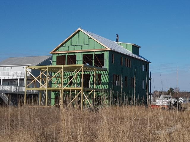 An R-3.7-insulated coated OSB wraps the exterior of the house in a continuous layer of thermal, air, and water protection.