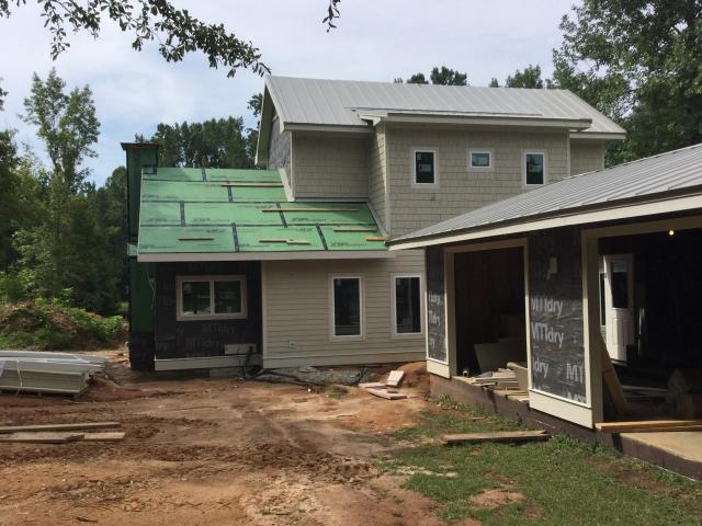 Imery keeps the home warm and dry by filling the walls with cellulose insulation then layering on a coated insulated sheathing, which is topped by a 3/8-inch rigid plastic channeled rain screen product and fiber cement siding.